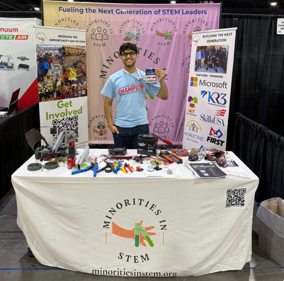 Rhythm at the Minorities in STEM booth at SkillsUSA, with robotics projects and outreach displays